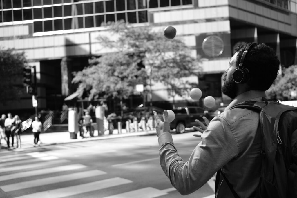 A person juggling tennis balls