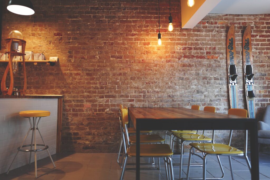 A coffee shop with a brick wall and warm lighting.