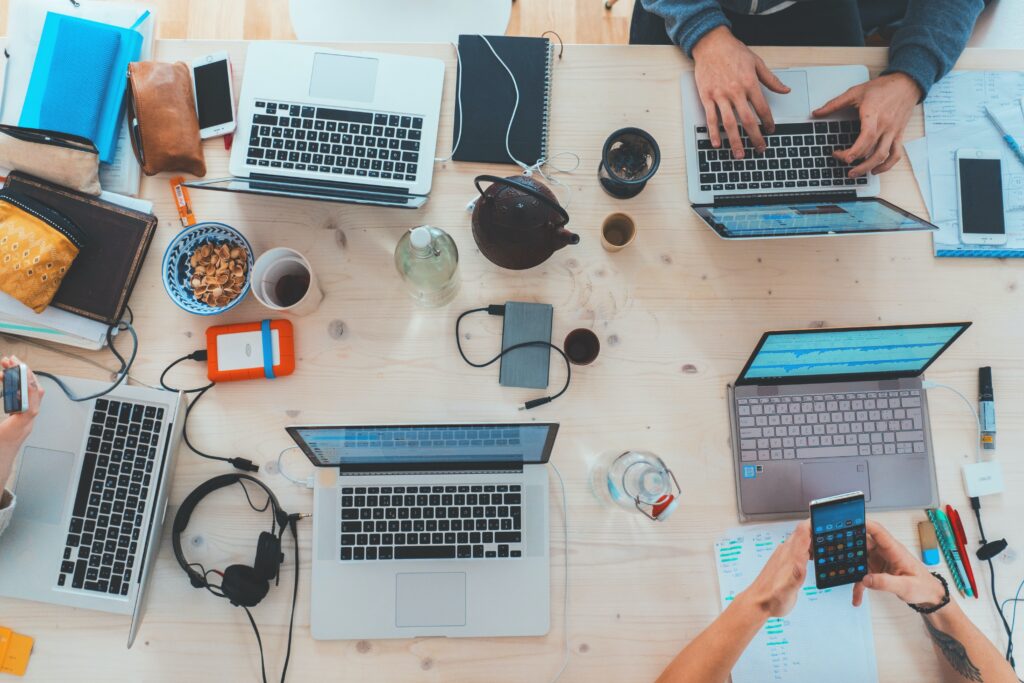 A shared workspace with multiple laptops out