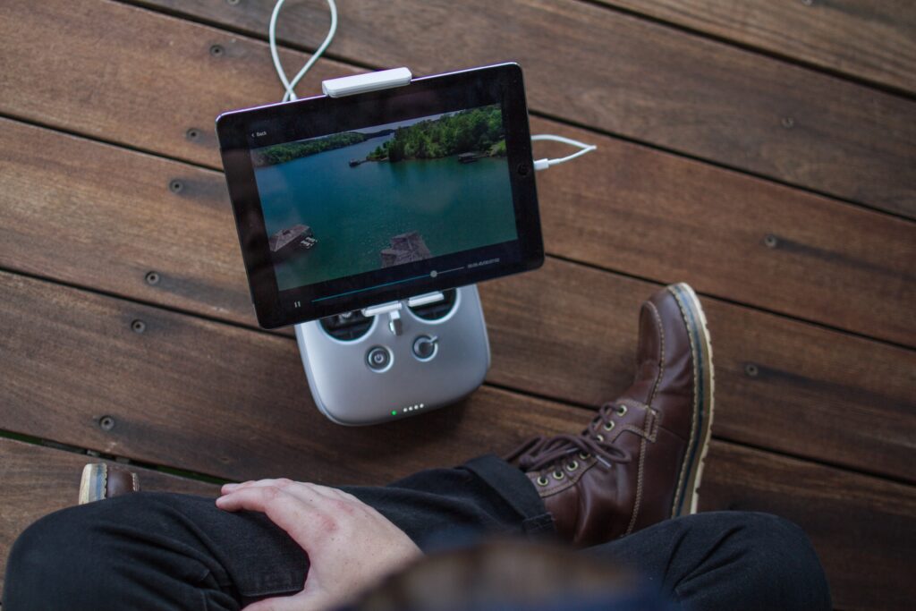 person sitting on the floor looking over an ipad on a portable mount