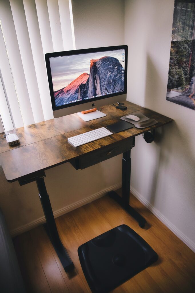 natural wood standing desk in a home office