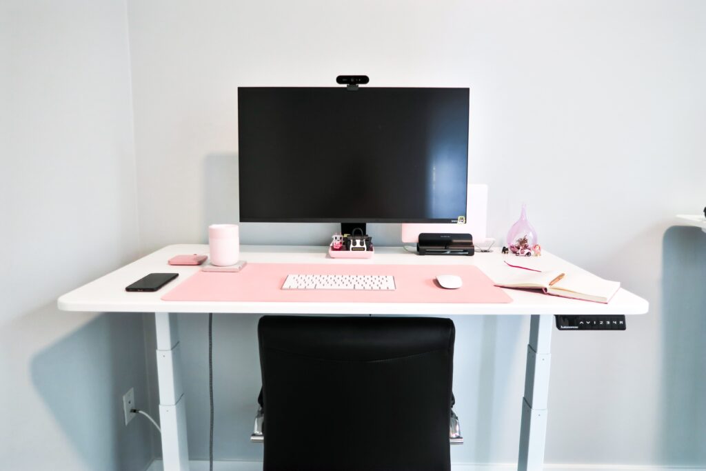 white standing desk with monitor in an office