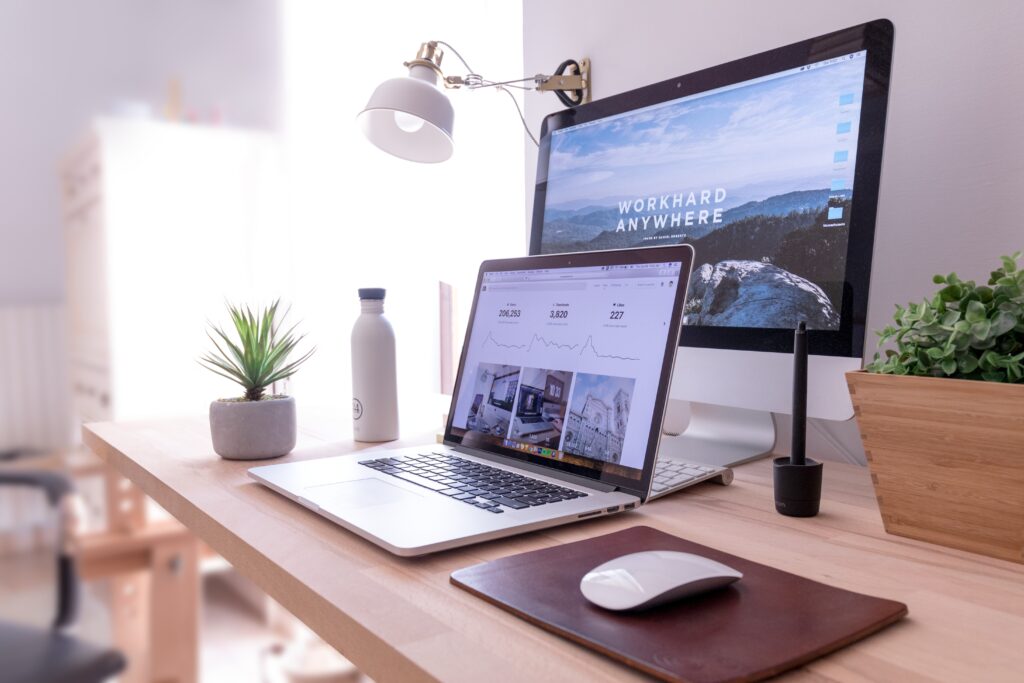 two computers on a desk in a home office.