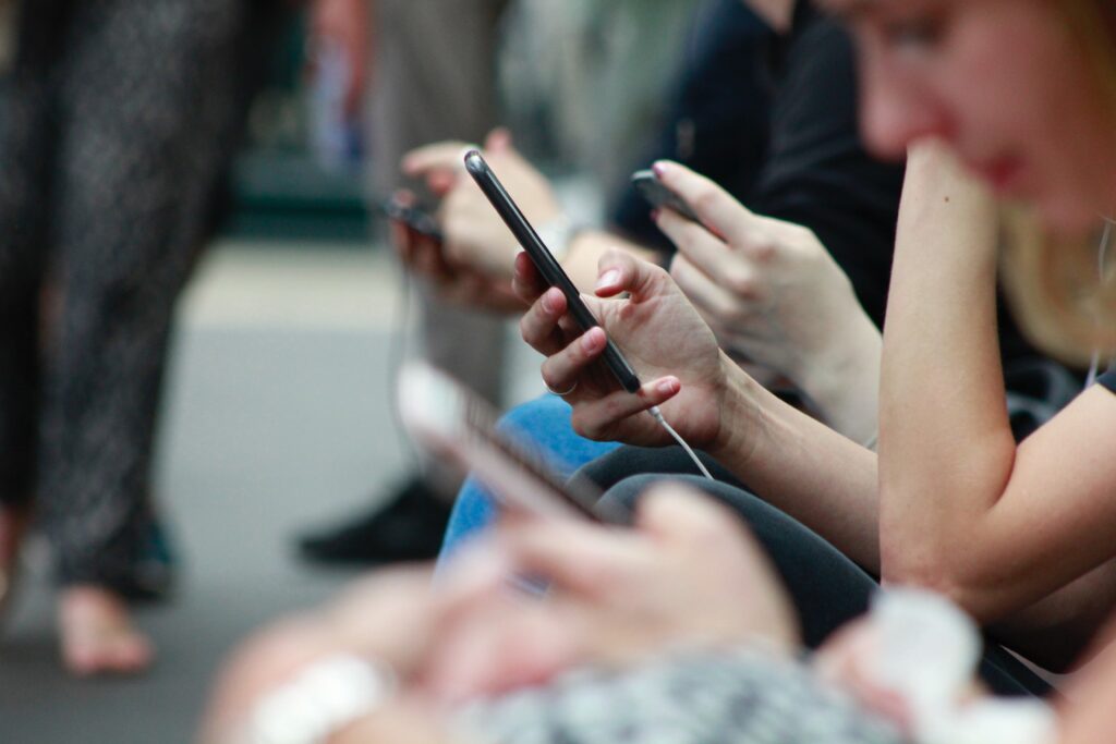 person in crowd looking at their phone