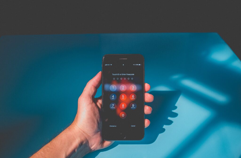 person holding iphone showing lock screen