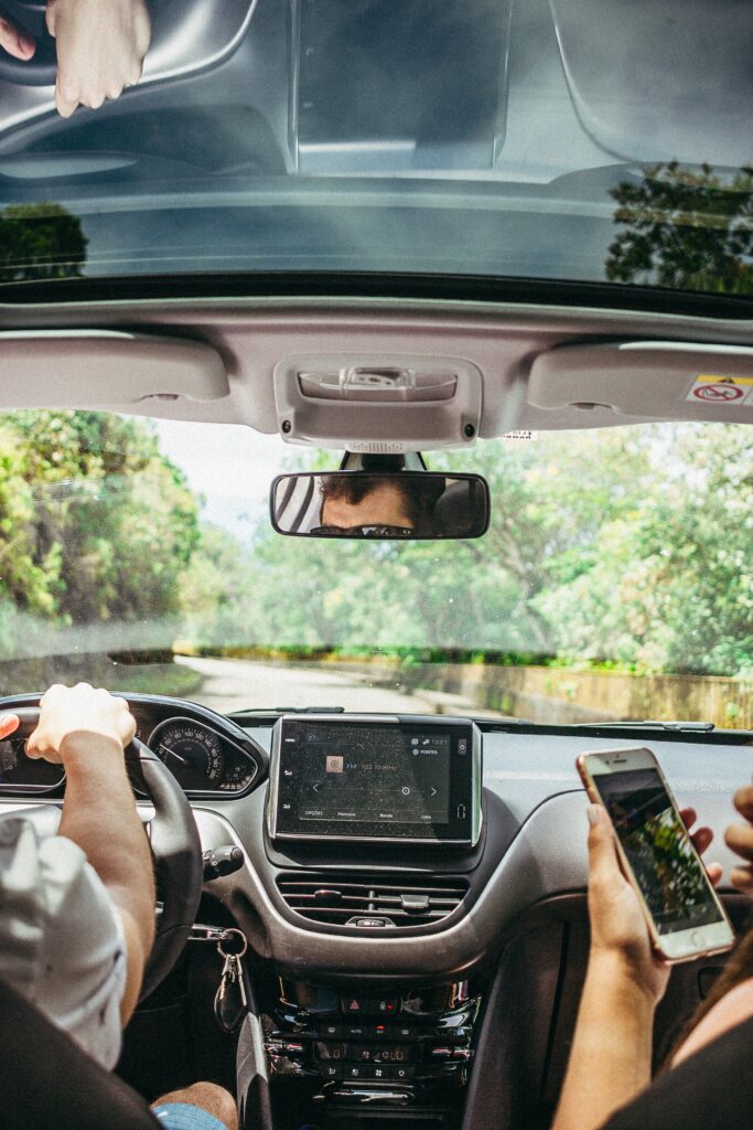 people driving while passenger is holding an iphone