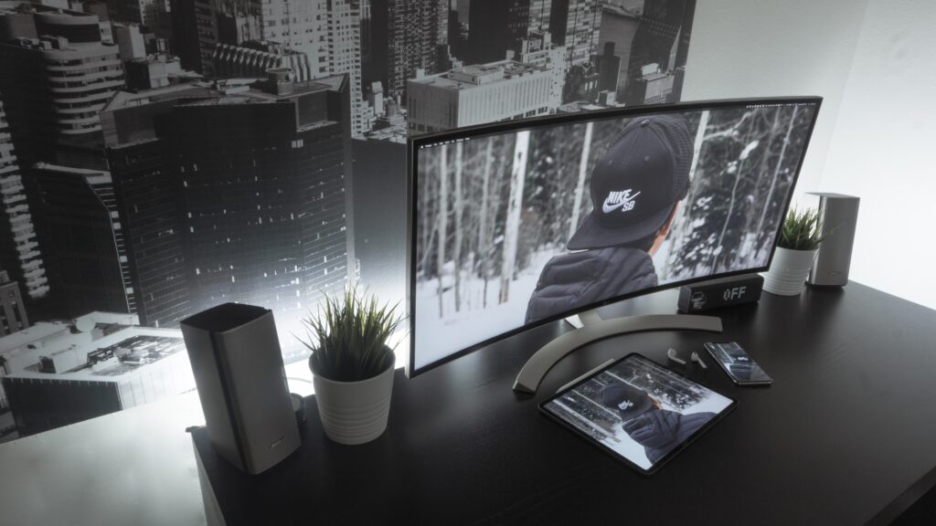 curved monitor sitting on black desk