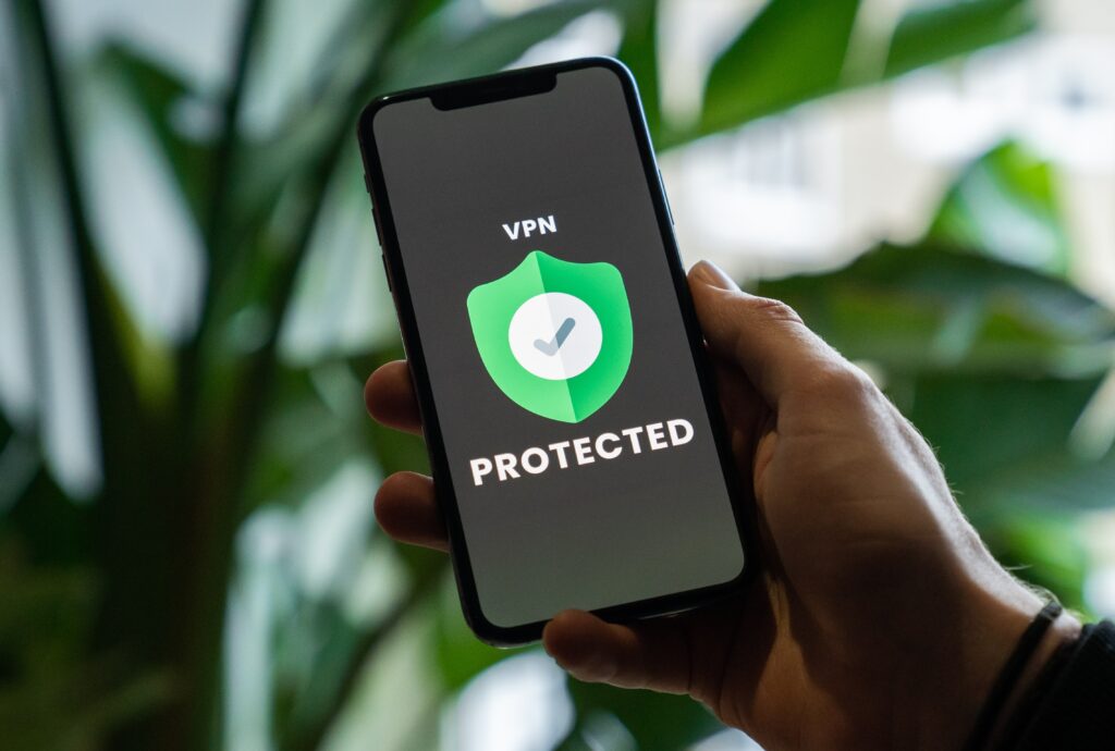 Person holding phone that show "VPN protected" on the screen