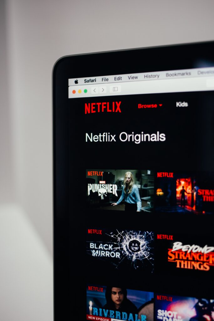 View of corner of laptop screen showing netflix logo and suggested shows.