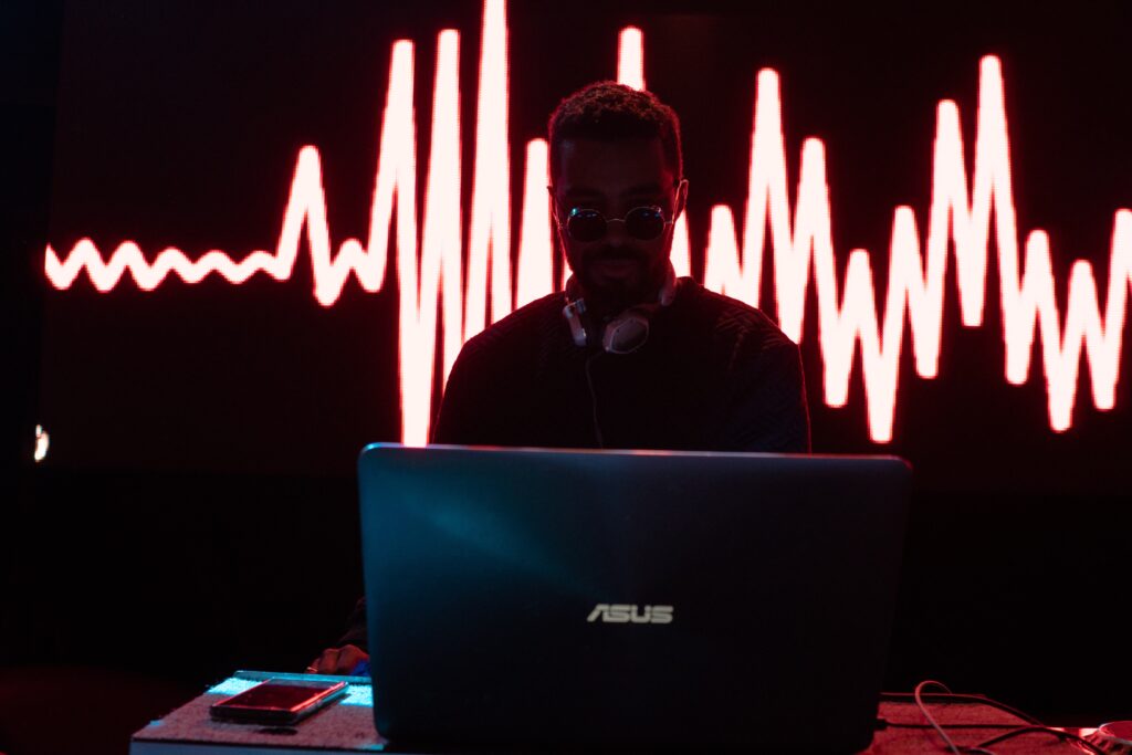 Person on ASUS computer with lights behind them.