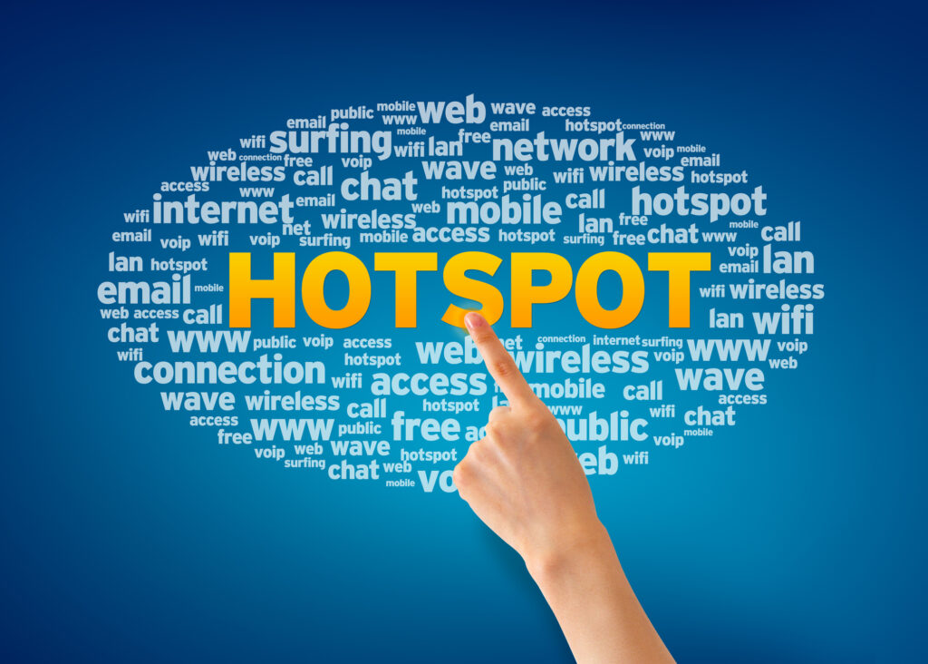 Hand pointing at a Hotspot Wordcloud on blue background.