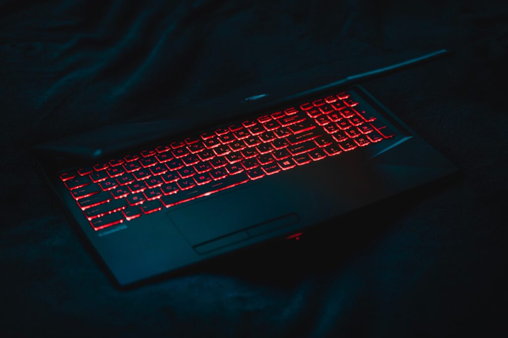 red backlit laptop keyboard in dark room