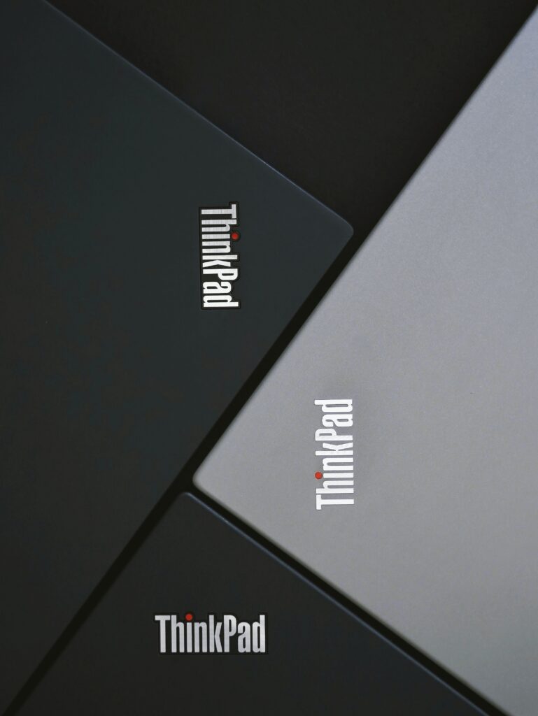 four lenovo thinkpad laptops lined up together