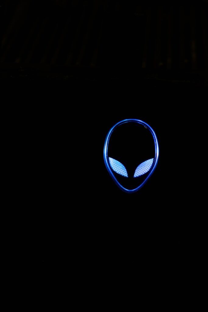 blue backlit Alienware logo on black background